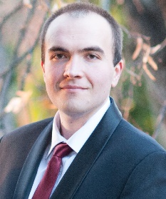 A person in a suit and tie

Description automatically generated