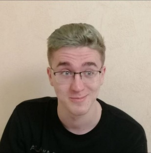 A person wearing glasses and smiling

Description automatically generated